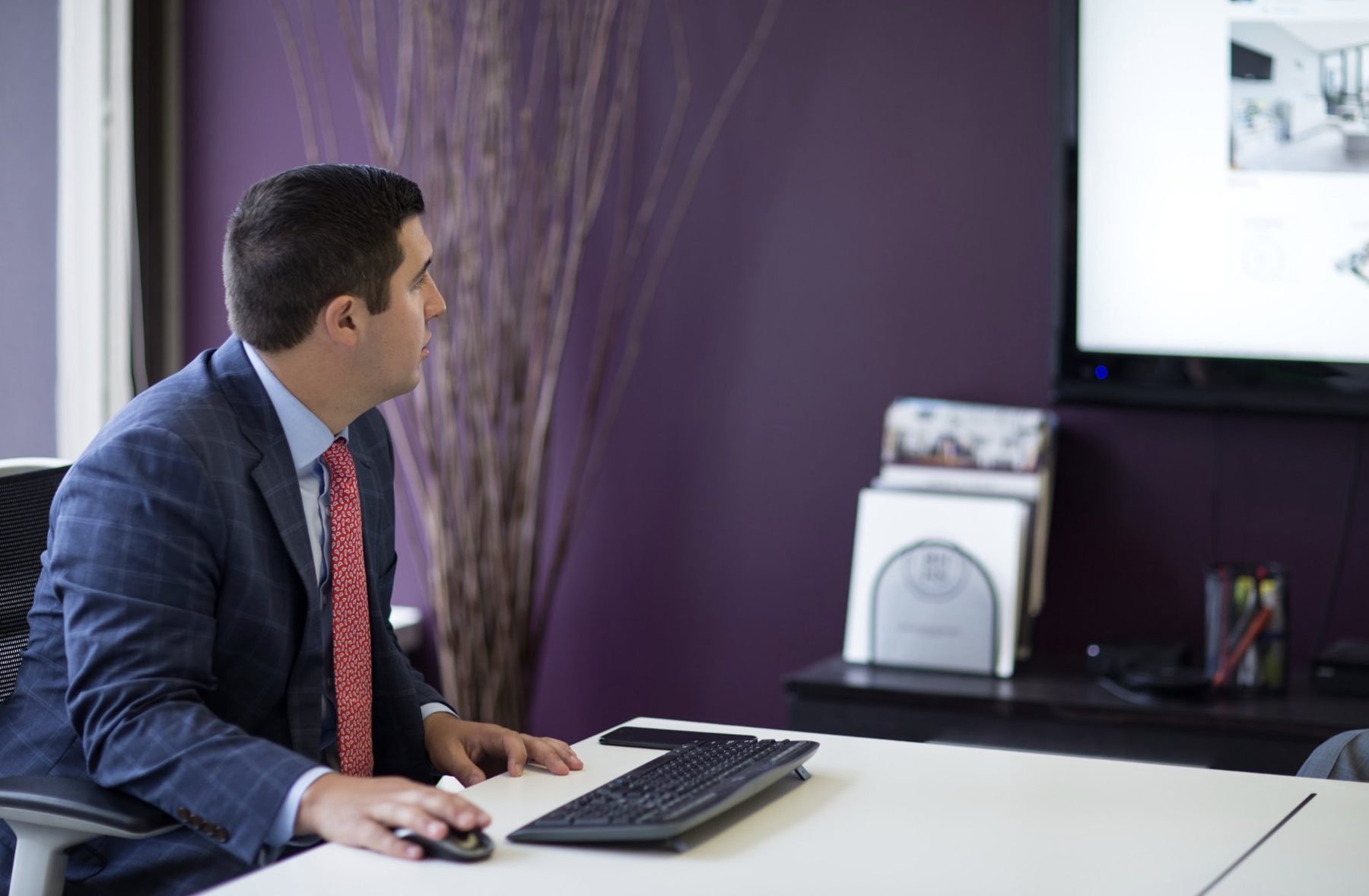 A Warren agent at his desk in the office
